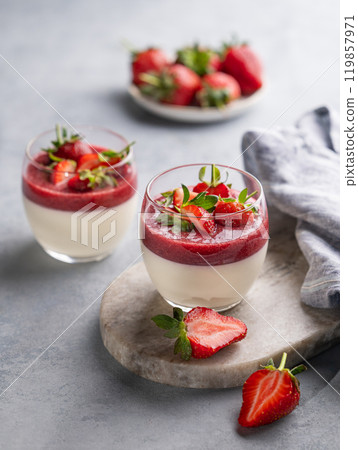 Strawberry and cream panna cotta in glasses with fresh berries on a marble board  119857971
