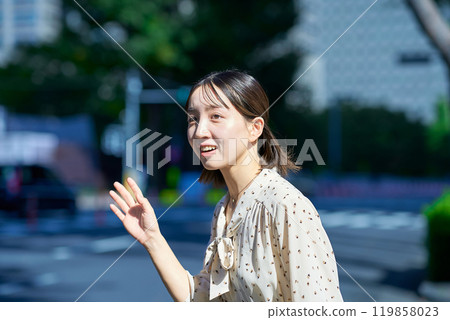 年輕女子在街上舉手 年輕女子在街上舉手 119858023