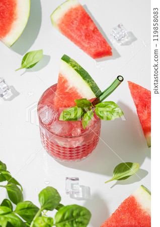 A glass of refreshing watermelon smoothie with basil, ice on a white background 119858083
