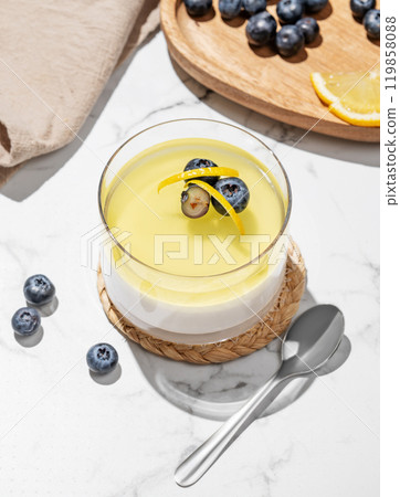 Creamy lemon panna cotta with blueberries in a glass on a light marble background with fresh berries Creamy lemon panna cotta with blueberries in a glass on a light marble background with fresh berries 119858088