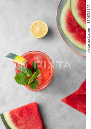 Flat lay of mojito cocktail with watermelon, lime, ice and mint in a glass on a light background Flat lay of mojito cocktail with watermelon, lime, ice and mint in a glass on a light background 119858105
