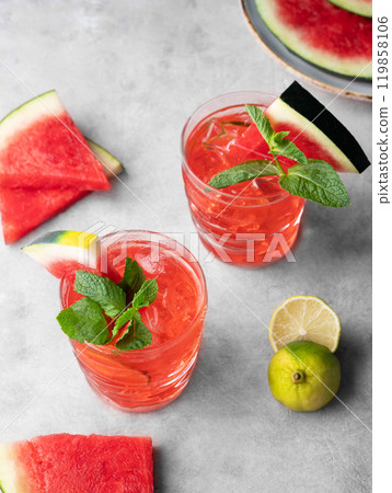 Flat lay of mojito cocktail with watermelon, lime, ice and mint in a two glasses Flat lay of mojito cocktail with watermelon, lime, ice and mint in a two glasses 119858106