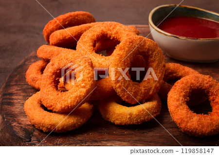 crispy chicken rings, fried, on a wooden board, close-up, 119858147
