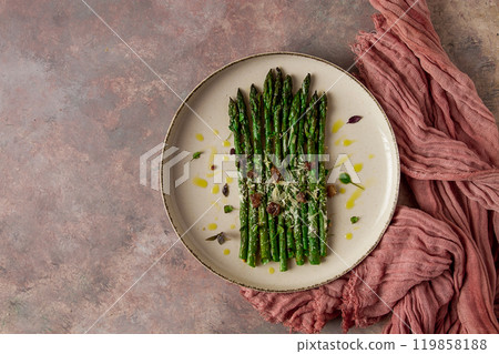 grilled asparagus , spices and herbs, parmesan cheese, on a beige plate, top view, rustic, no people grilled asparagus , spices and herbs, parmesan cheese, on a beige plate, top view, rustic, no people 119858188