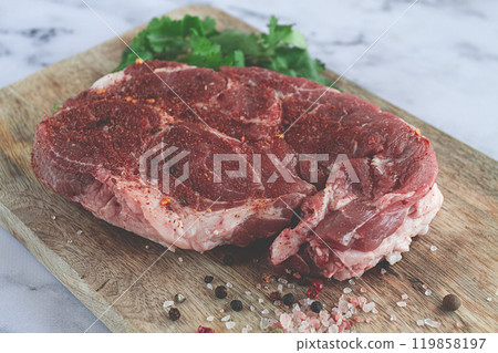 raw pork steak , pork neck, on a chopping board, marble table, top view, with spices and coriander, no people, 119858197