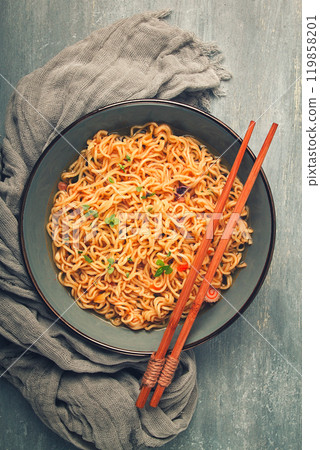 Instant noodles, in a bowl, on a gray table, top view, no people, 119858201