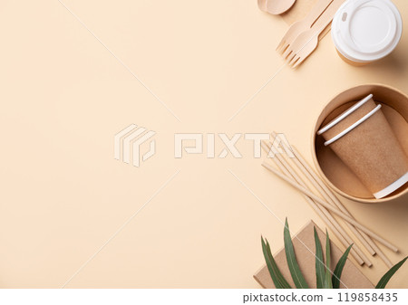 Set of eco-friendly disposable tableware with wooden cutlery, brown paper cups, bowls Set of eco-friendly disposable tableware with wooden cutlery, brown paper cups, bowls 119858435