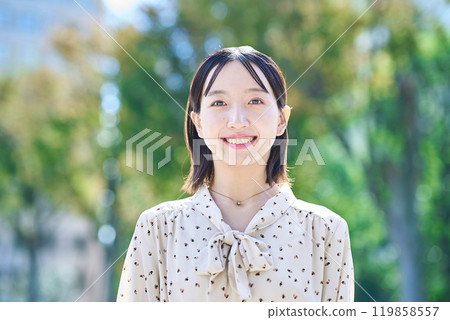 Portrait of a young woman relaxing in green space Portrait of a young woman relaxing in green space 119858557