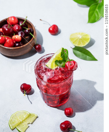 Cherry-lime mojito cocktail with mint, lime and ice on a light background with fresh berries 119858683