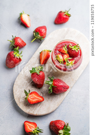 Strawberry and cream panna cotta in glass with fresh berries on a marble board on a light background Strawberry and cream panna cotta in glass with fresh berries on a marble board on a light background 119858755