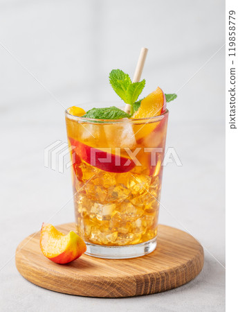 Refreshing peach iced mint tea. The concept of a healthy homemade cold summer drink Refreshing peach iced mint tea. The concept of a healthy homemade cold summer drink 119858779
