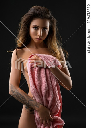 Slim nude girl wrapped in pink towel shot 119858880