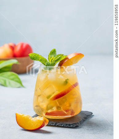 Refreshing peach cocktail, lemonade or iced tea on a light background. 119858958