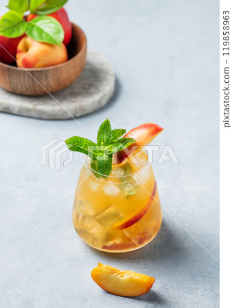 Refreshing peach cocktail, lemonade or iced tea on a light background. 119858963