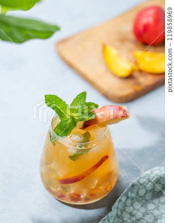 Refreshing peach cocktail, lemonade or iced tea on a light background with shadow. 119858969