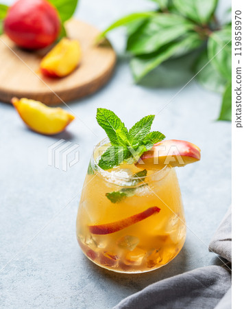 Refreshing peach cocktail, lemonade or iced tea on a light background. 119858970