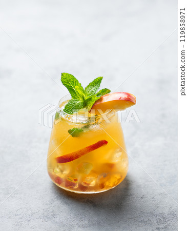 Refreshing peach cocktail, lemonade or iced tea on a light background. Refreshing peach cocktail, lemonade or iced tea on a light background. 119858971