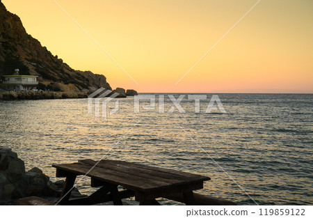 sunset on a Mediterranean coastal beach 119859122