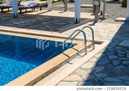 Closeup stair in the blue swimming pool background 119859319