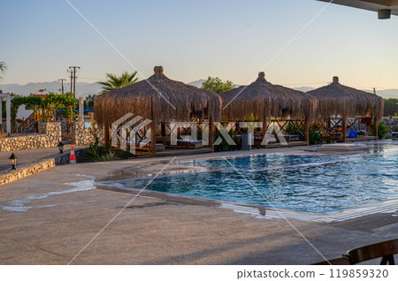 Cozy gazebo near swimming pool 119859320