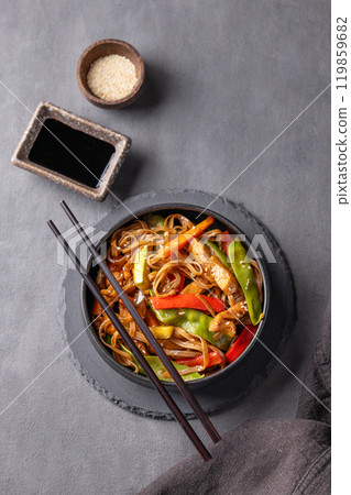 Stir-fry with soba noodles, chicken and vegetables. Asian fast and healthy food concept Stir-fry with soba noodles, chicken and vegetables. Asian fast and healthy food concept 119859682