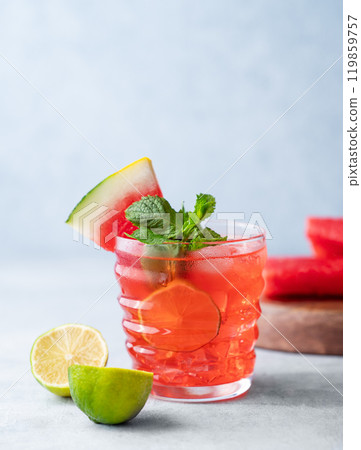 Mojito cocktail with watermelon, lime, ice and mint in a glass on a light background with fruits Mojito cocktail with watermelon, lime, ice and mint in a glass on a light background with fruits 119859757