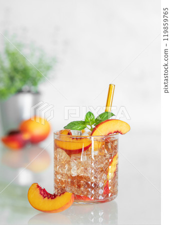 Peach refreshing drink with ice and mint on a white background. Fresh homemade lemonade in a glass Peach refreshing drink with ice and mint on a white background. Fresh homemade lemonade in a glass 119859765