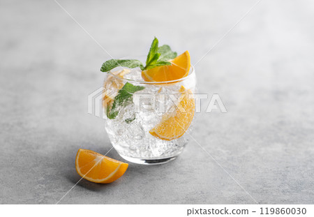 Lemonade tonic drink with fresh lemon, mint and ice on a light background. 119860030