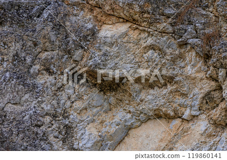 Unique rock formation resembling a face in nature at a remote location during daylight 119860141