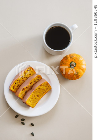 Slices of pumpkin sweet bread or cake with icing on a plate on a light background  119860349