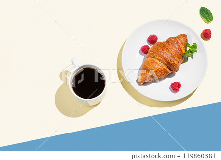 Fresh croissant on a white plate with raspberry and cup of espresso coffee  119860381
