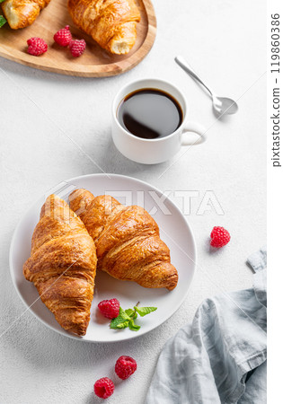 Cup of espresso coffee and croissants with fresh raspberries and mint on a plate Cup of espresso coffee and croissants with fresh raspberries and mint on a plate 119860386