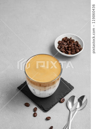 Iced dalgona coffee. Whipped instant coffee in a glass with ice on a slate board  119860436