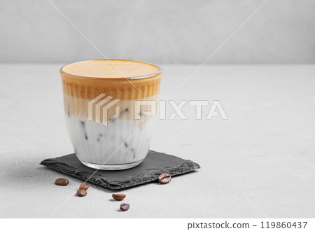 Iced dalgona coffee. Whipped instant coffee in a glass with ice on a slate board  119860437