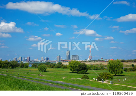 View of the residential area of Kawaguchi Motogo from the banks of the Arakawa River. White clouds in the blue sky. View of the residential area of Kawaguchi Motogo from the banks of the Arakawa River. White clouds in the blue sky. 119860459