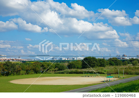 Arakawa riverbed ground and white clouds in the blue sky, Ogi Ohashi Bridge and Nippori Toneri Liner 119860468