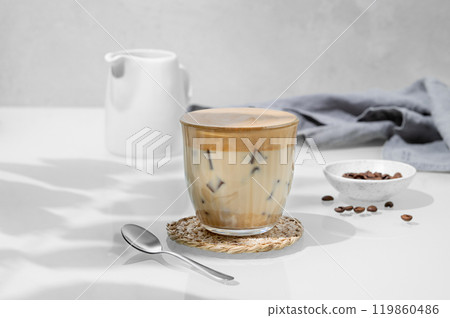Iced dalgona coffee. Whipped instant coffee in a glass with ice on a light background 119860486