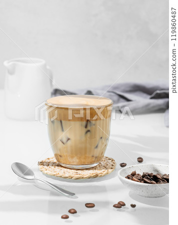 Dalgona coffee. Whipped instant coffee in a glass with ice on a white background Dalgona coffee. Whipped instant coffee in a glass with ice on a white background 119860487