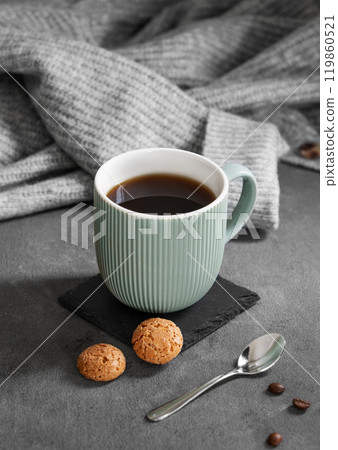 Espresso coffee in a mug on a dark background with cookies, spoon, coffee beans Espresso coffee in a mug on a dark background with cookies, spoon, coffee beans 119860521