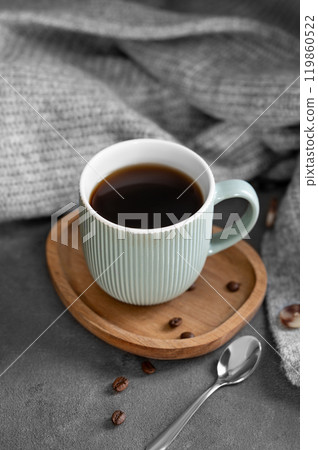 Espresso coffee in a mug on a wooden board on a dark background with coffee beans, spoon Espresso coffee in a mug on a wooden board on a dark background with coffee beans, spoon 119860522