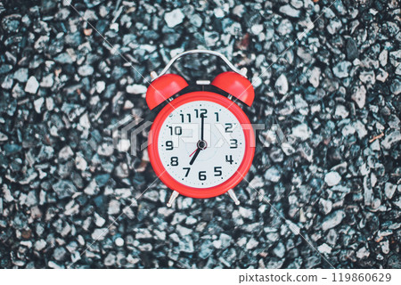 Red alarm clock and asphalt background 119860629