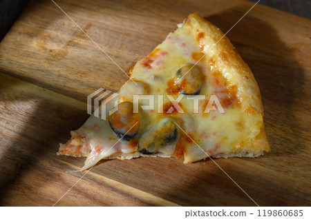 Italian Pizza with seafood and mozzarella cheese on wooden board. Close up 119860685