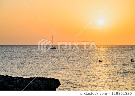 Beautiful sunset with orange sky on the beach of Menorca, Balearic Islands. Sunset, nature Beautiful sunset with orange sky on the beach of Menorca, Balearic Islands. Sunset, nature 119861520