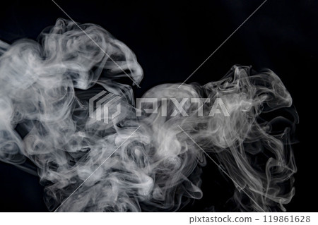 Smoke or steam blowing in the wind on a black background 119861628
