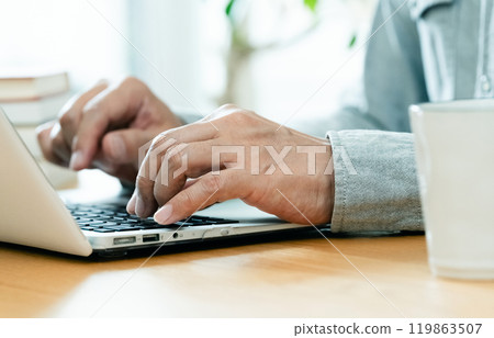 Male hand operating a personal computer Male hand operating a personal computer 119863507