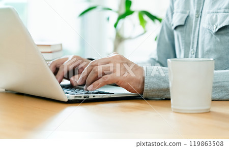 Male hand operating a personal computer Male hand operating a personal computer 119863508