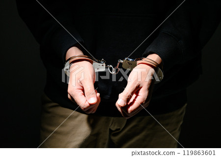 Handcuffed male hand 119863601