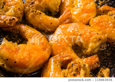 Garlic shrimp cooking in a frying pan 119863656