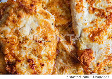 cooked chicken chops on white plate on table close up 119863844