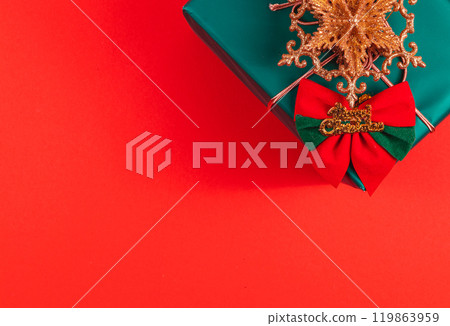 A gift box with a Christmas star decoration and the inscription Merry Christmas A gift box with a Christmas star decoration and the inscription Merry Christmas 119863959